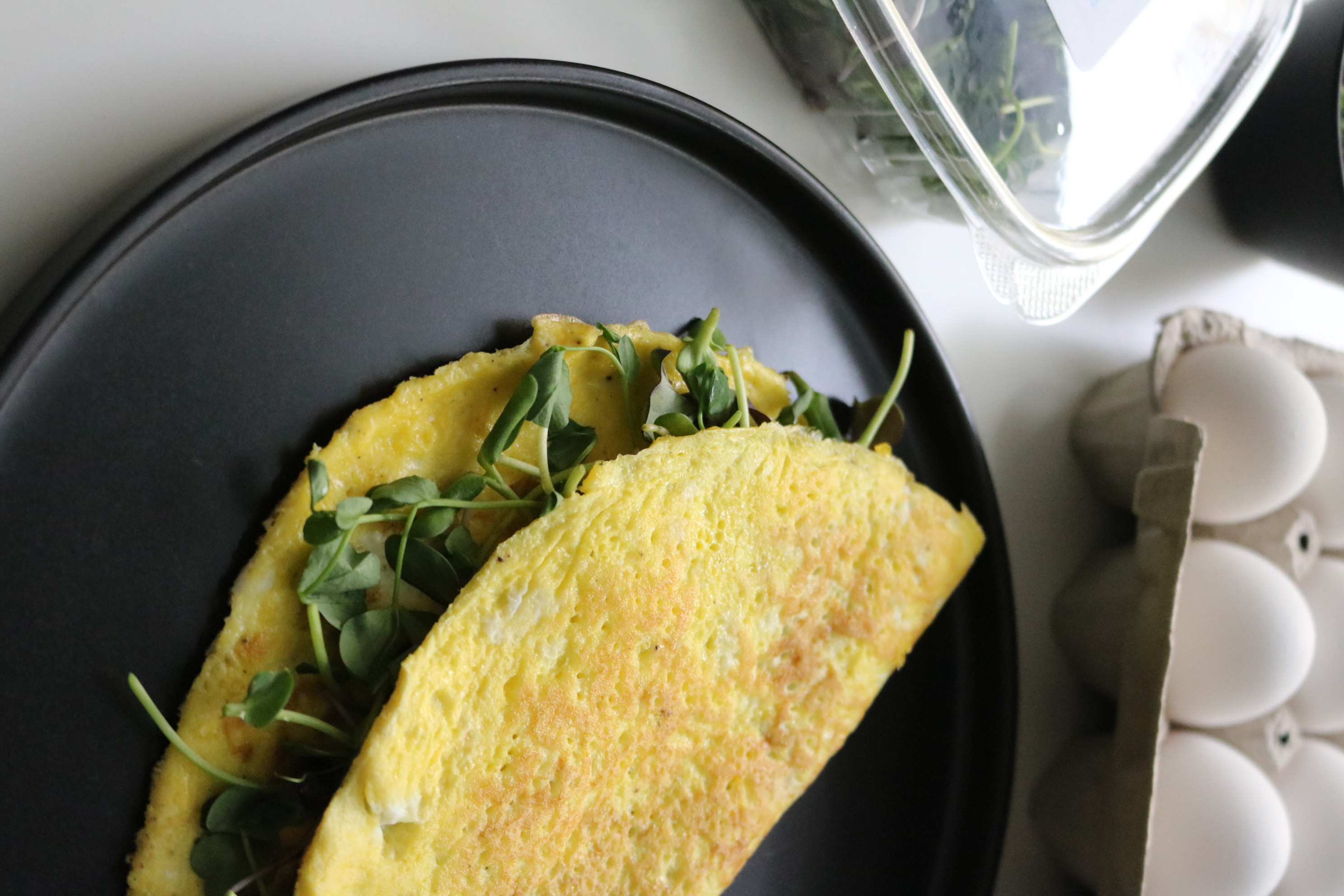 Omelet topped with fresh microgreens
